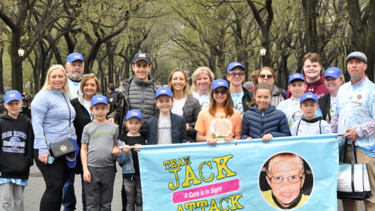 A group of team members hold a banner at the Vision Walk